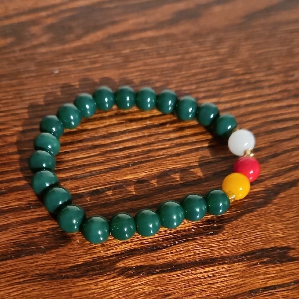 Green Beaded Bracelet with Red, Yellow, and White Accents